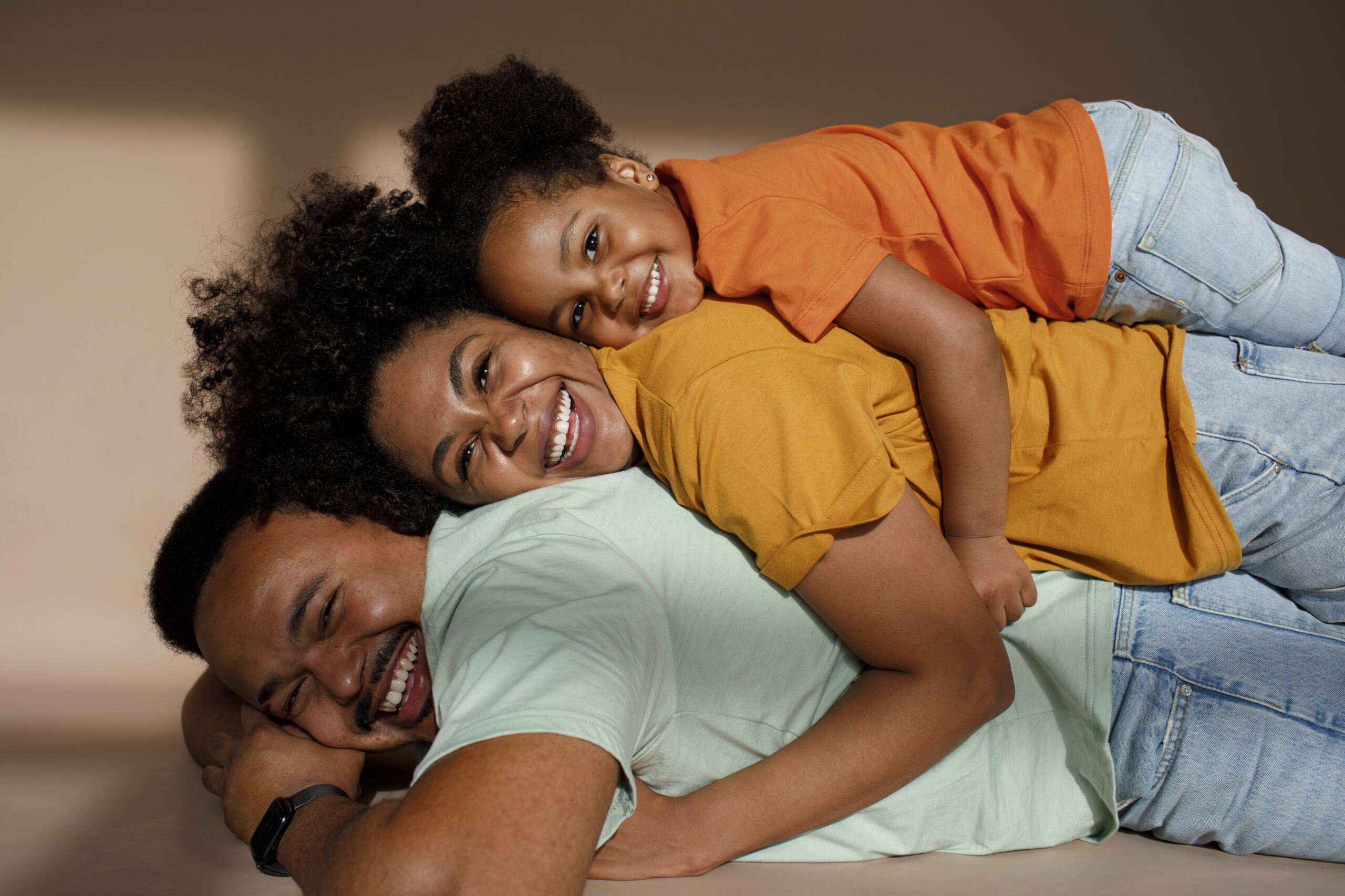 medium-shot-black-family-posing-studio